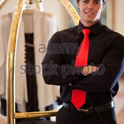 porter-with-luggage-cart-in-hotel-lobby-d38ak5